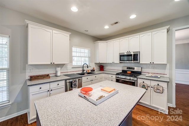 kitchen featuring white cabinetry, a wealth of natural light, sink, and appliances with stainless steel finishes