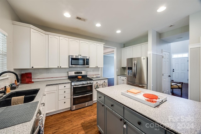 kitchen featuring white cabinetry, sink, stainless steel appliances, dark hardwood / wood-style floors, and gray cabinets