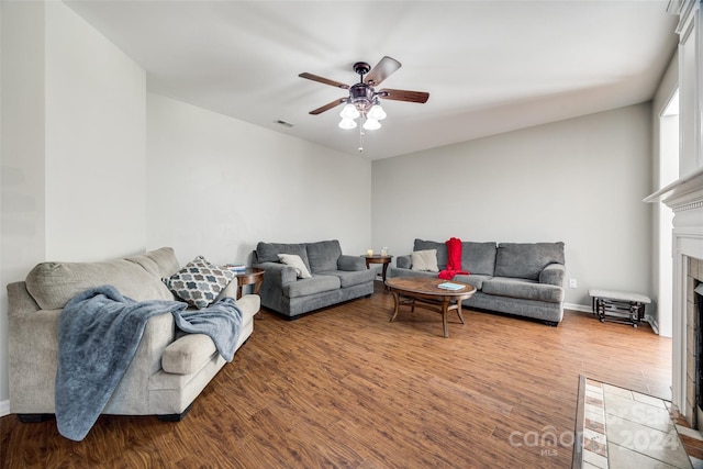 living room featuring ceiling fan and hardwood / wood-style flooring