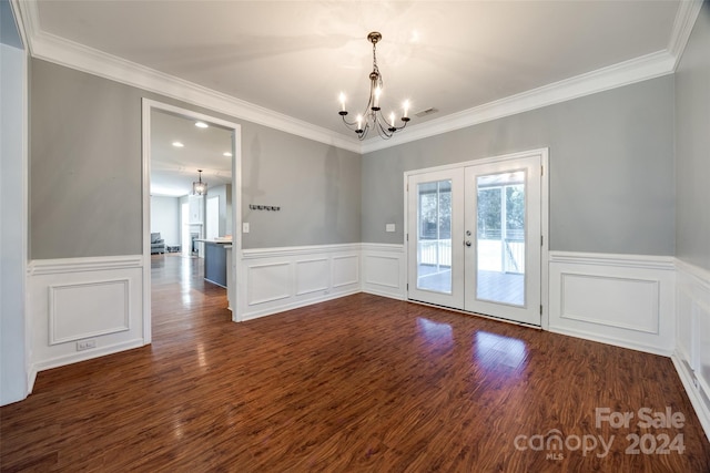 unfurnished room featuring a chandelier, crown molding, french doors, and dark wood-type flooring