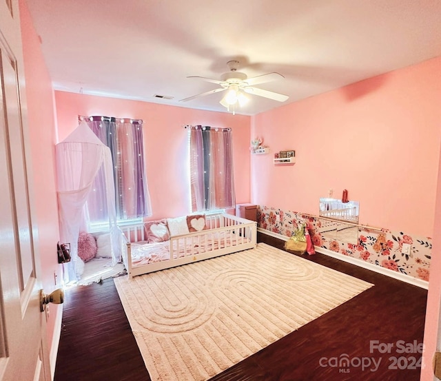 bedroom featuring ceiling fan and dark wood-type flooring