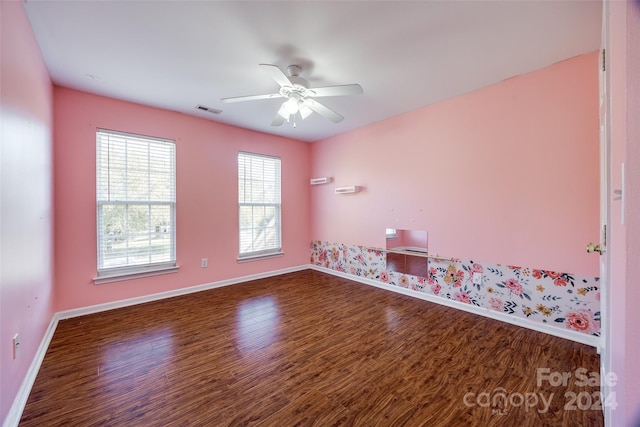 unfurnished room with ceiling fan and dark hardwood / wood-style flooring