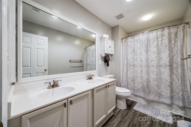 bathroom with hardwood / wood-style flooring, vanity, toilet, and a shower with curtain