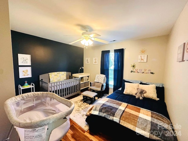 bedroom with ceiling fan and hardwood / wood-style floors