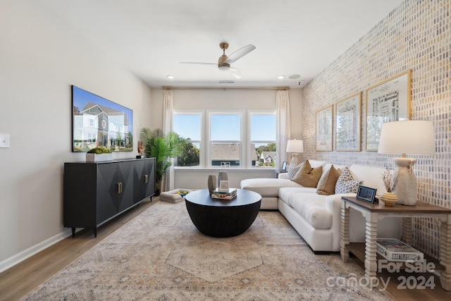 living room featuring ceiling fan and hardwood / wood-style floors