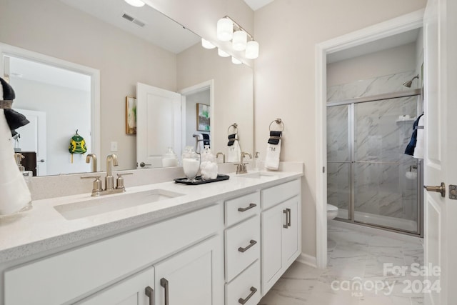 bathroom with vanity, toilet, and an enclosed shower