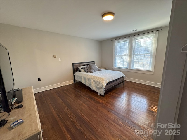 bedroom featuring dark hardwood / wood-style flooring