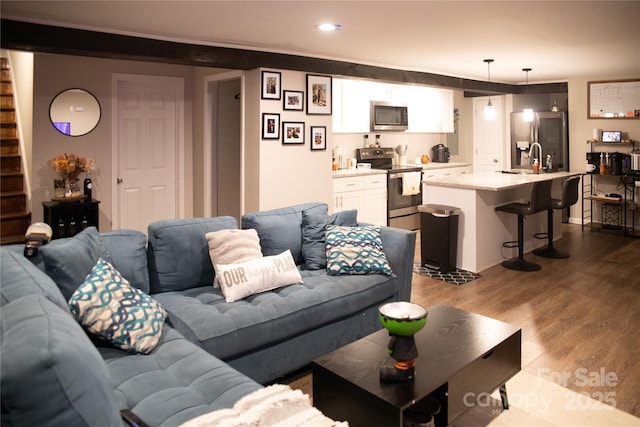 living room with sink and light hardwood / wood-style floors