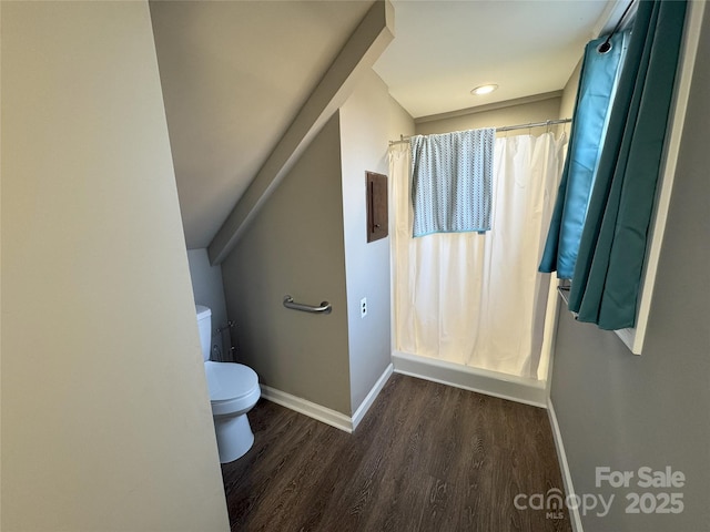 bathroom featuring hardwood / wood-style floors, toilet, and a shower with shower curtain