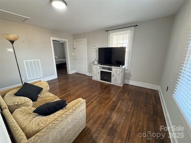 unfurnished living room with dark hardwood / wood-style floors