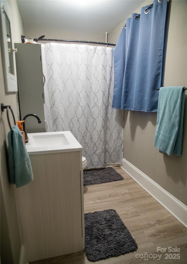 bathroom with vanity, toilet, hardwood / wood-style floors, and a shower with shower curtain