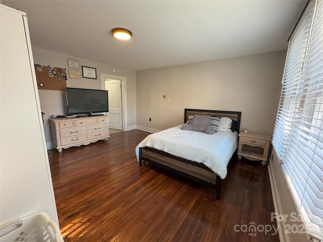 bedroom with dark wood-type flooring