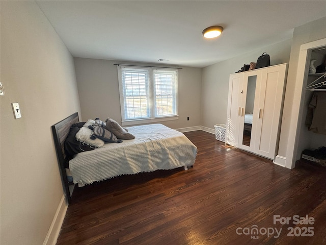 bedroom with dark wood-type flooring