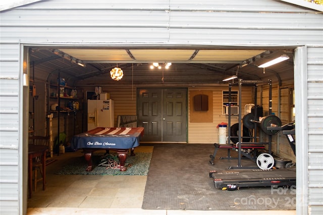 garage featuring white refrigerator with ice dispenser