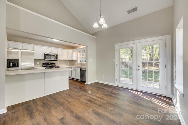 kitchen with white cabinets, stainless steel appliances, and dark hardwood / wood-style flooring