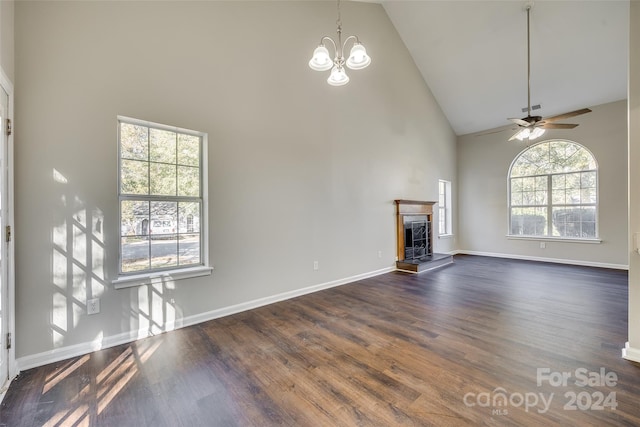 unfurnished living room featuring a healthy amount of sunlight, dark hardwood / wood-style floors, high vaulted ceiling, and a fireplace