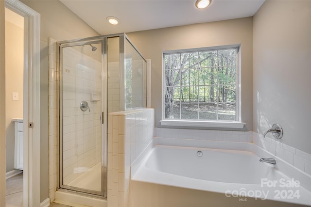 bathroom featuring independent shower and bath