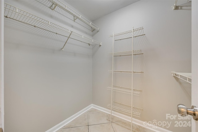 spacious closet featuring light tile patterned floors