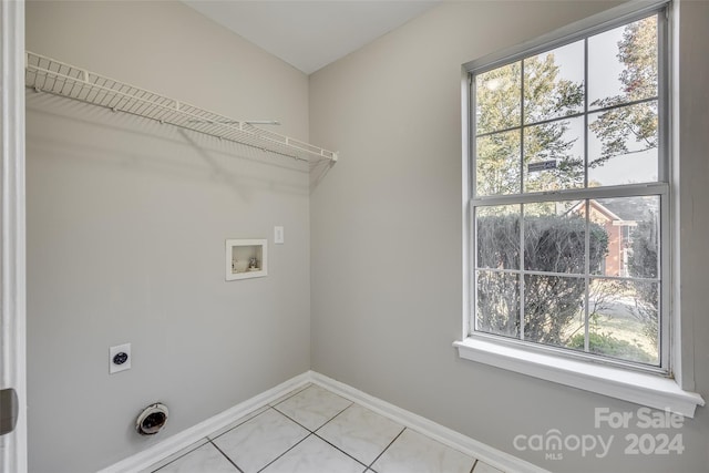 laundry room featuring hookup for an electric dryer, washer hookup, and light tile patterned floors