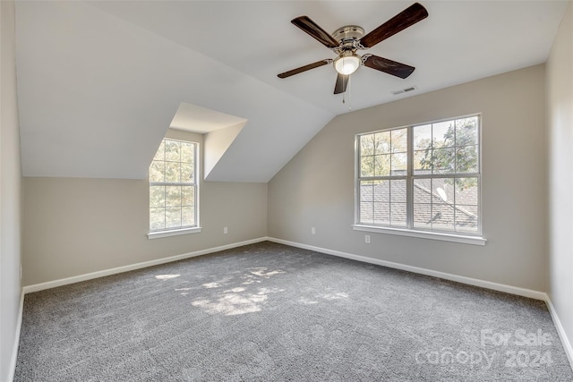 additional living space with lofted ceiling, carpet floors, and ceiling fan