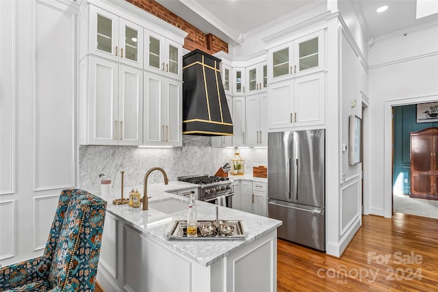 kitchen featuring custom exhaust hood, white cabinets, kitchen peninsula, and stainless steel appliances