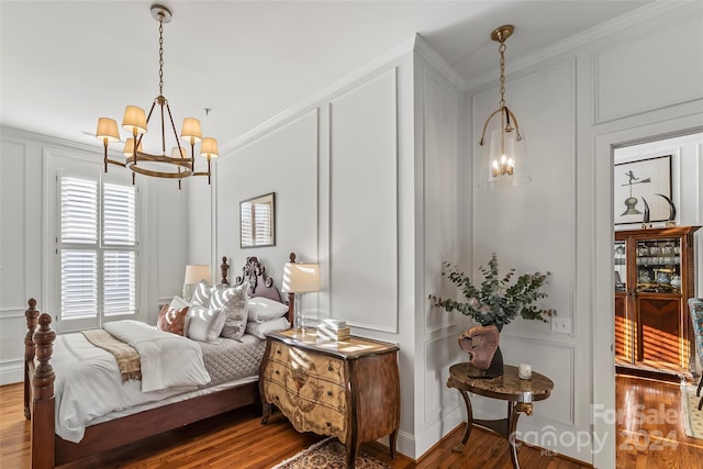 bedroom with ornamental molding, a chandelier, and wood-type flooring