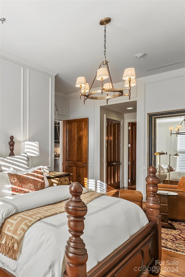 bedroom featuring ornamental molding and wood-type flooring