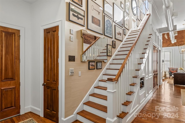 stairway with baseboards and wood finished floors