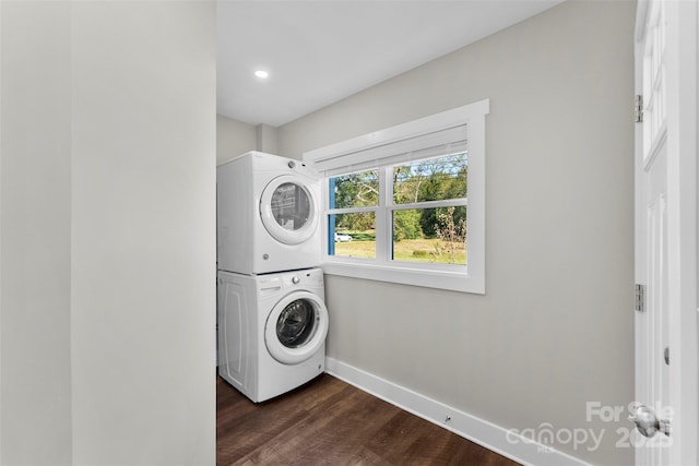 laundry room with dark hardwood / wood-style flooring and stacked washer / drying machine