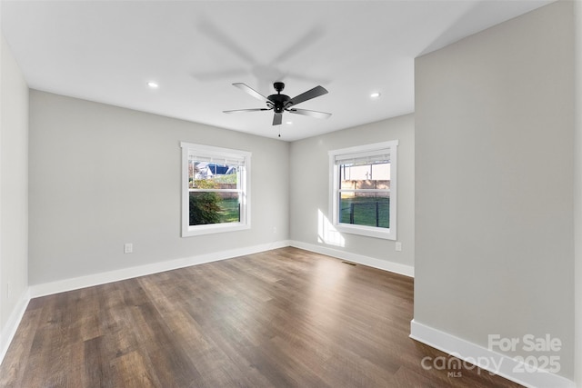 unfurnished room featuring ceiling fan and dark hardwood / wood-style flooring