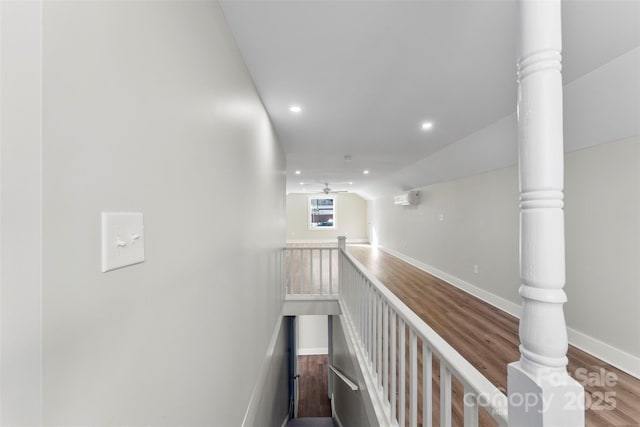 hall featuring lofted ceiling and hardwood / wood-style flooring