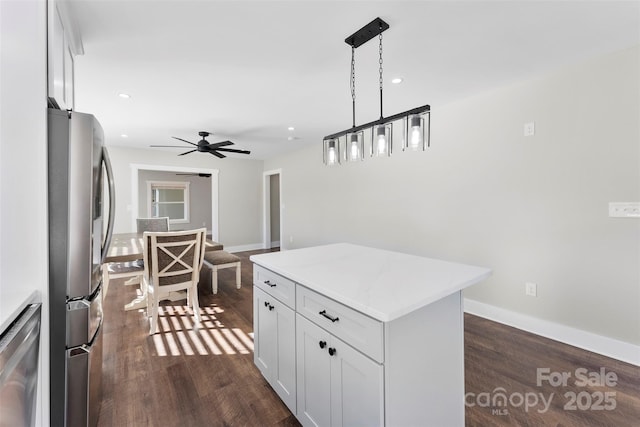 kitchen featuring white cabinetry, hanging light fixtures, a kitchen island, and stainless steel appliances