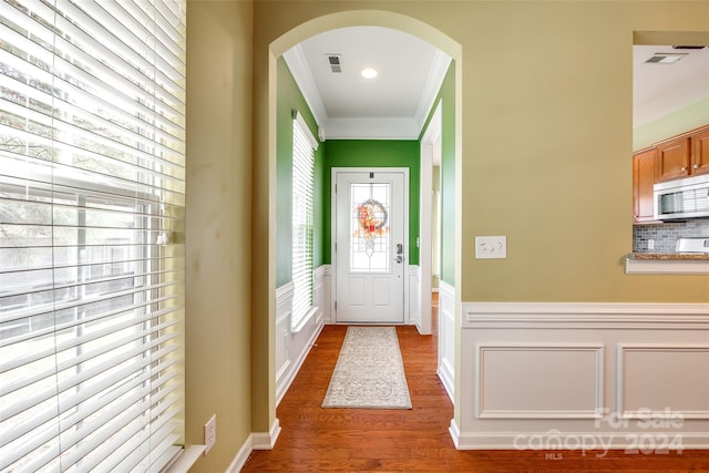 entryway featuring ornamental molding and dark wood-type flooring