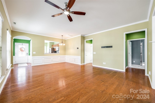 unfurnished living room with dark wood-type flooring and crown molding