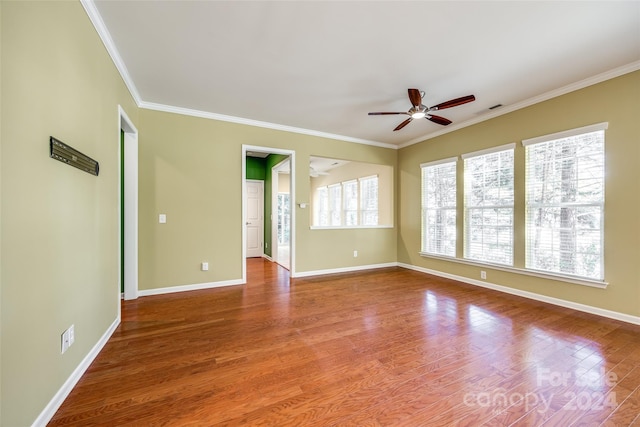 spare room with ceiling fan, crown molding, and hardwood / wood-style floors