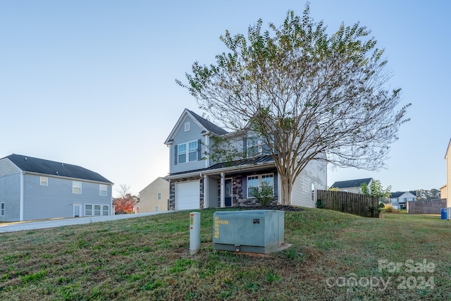 view of property with a front yard and a garage