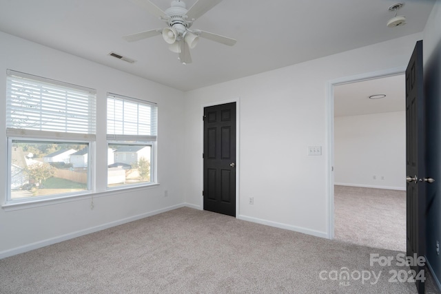 unfurnished bedroom with light carpet and ceiling fan