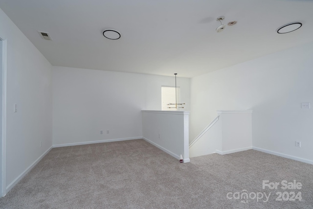 empty room featuring light colored carpet