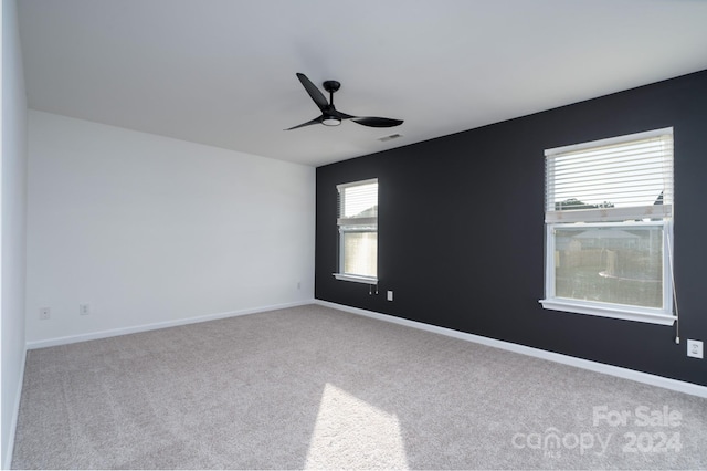 spare room featuring ceiling fan, carpet floors, and plenty of natural light