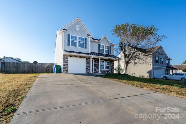 view of front property featuring a front lawn and a garage