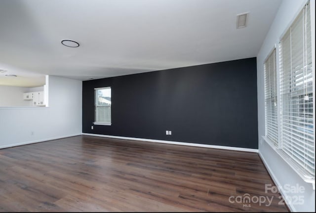 empty room featuring dark hardwood / wood-style flooring