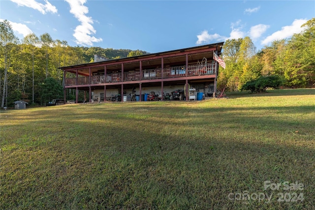 rear view of property with a yard and a deck