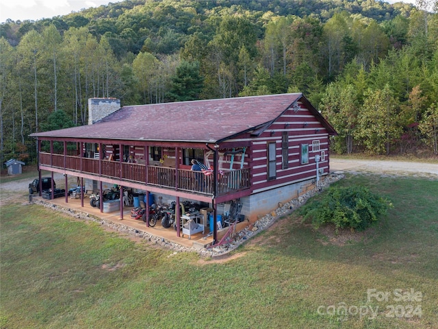 exterior space featuring a patio, a front yard, and a deck