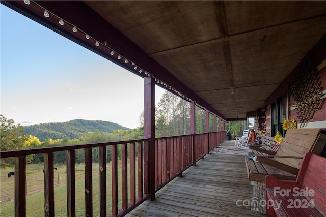 wooden deck with a mountain view