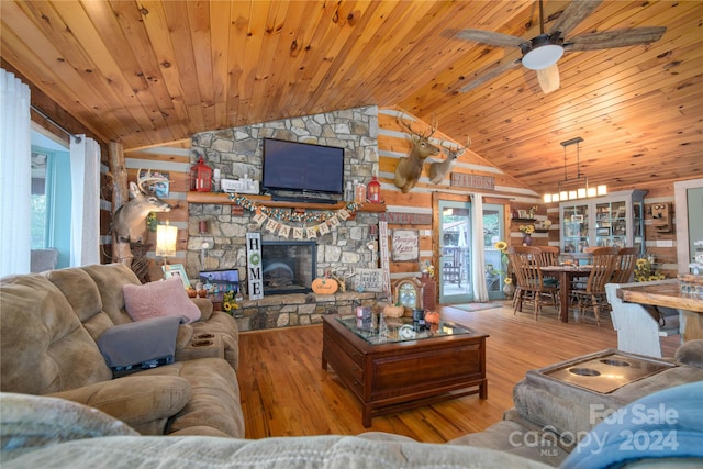 living room with light hardwood / wood-style floors, wooden ceiling, vaulted ceiling, and ceiling fan