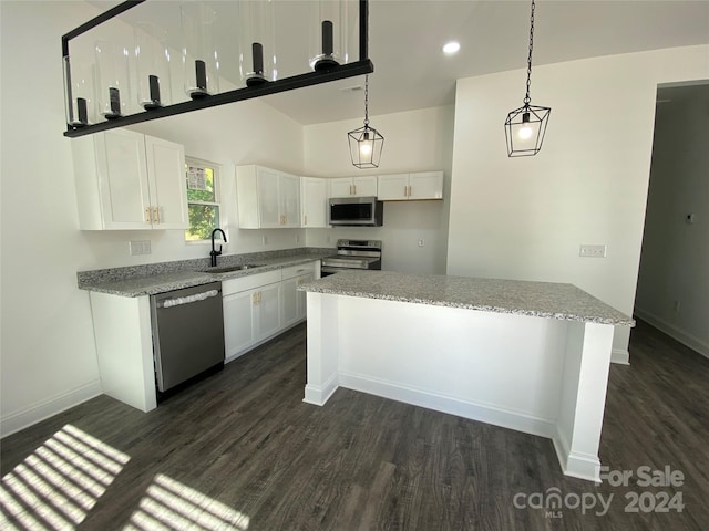 kitchen featuring light stone countertops, sink, hanging light fixtures, white cabinetry, and stainless steel appliances