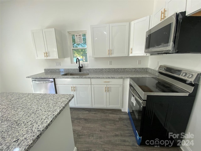 kitchen featuring sink, appliances with stainless steel finishes, dark hardwood / wood-style floors, and white cabinetry