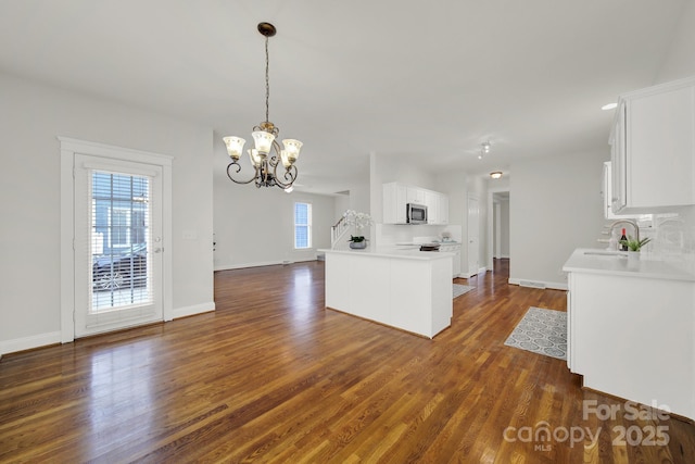 kitchen featuring sink, white cabinets, a chandelier, and dark hardwood / wood-style floors