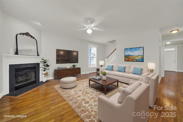 living room with ceiling fan and wood-type flooring