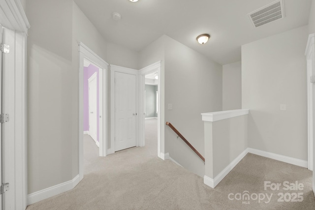 hallway with light colored carpet